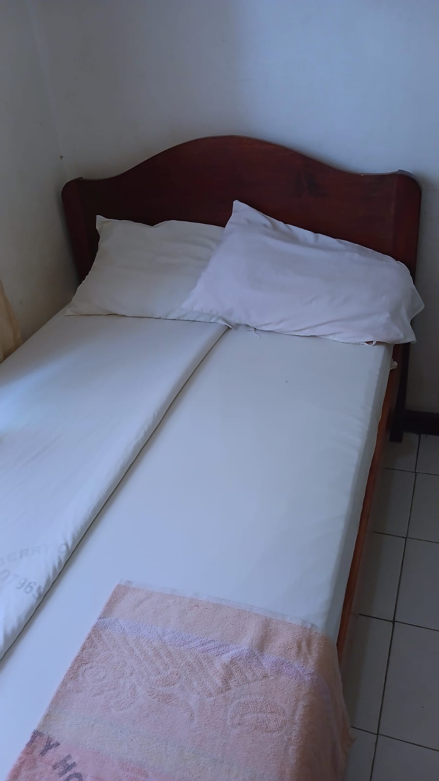The Single Room — bed with pillows